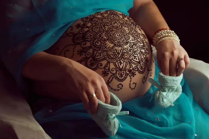 Barriga embarazada pintada intrincados mandalas